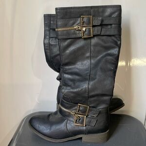 Tall black boots with gold accents